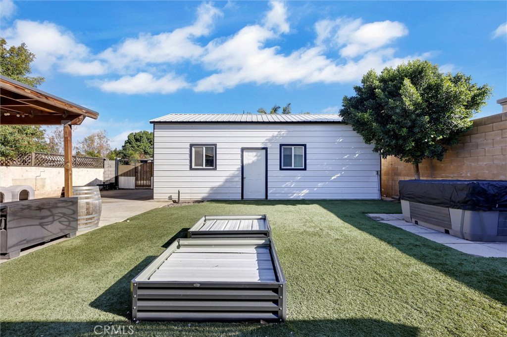15936 Dauchy Avenue Riverside, CA 92508 - Photo 23 of 25 a view of a backyard with couches plants and large tree