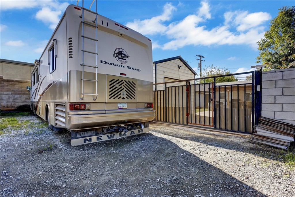 15936 Dauchy Avenue Riverside, CA 92508 - Photo 25 of 25 a view of a house with a yard and wooden fence