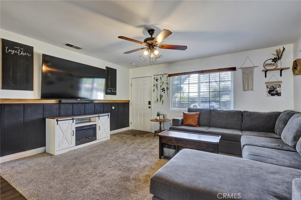 15936 Dauchy Avenue Riverside, CA 92508 - Photo 6 of 25 a living room with furniture and a flat screen tv