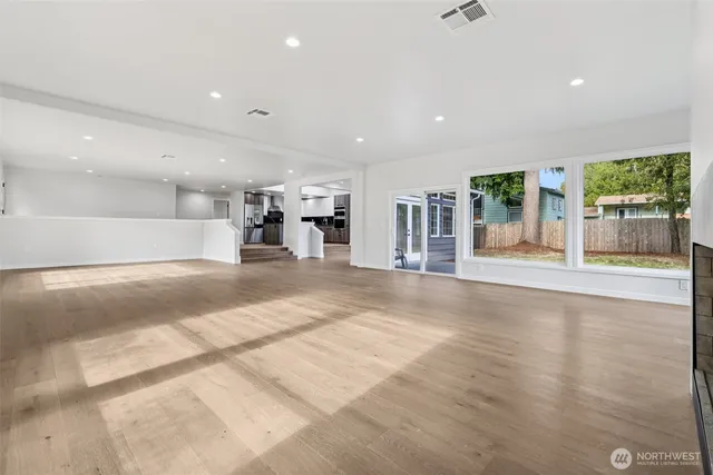 a kitchen with kitchen island granite countertop a large counter top stainless steel appliances and cabinets