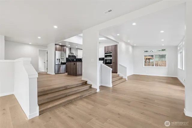 a dining room with furniture and a kitchen view