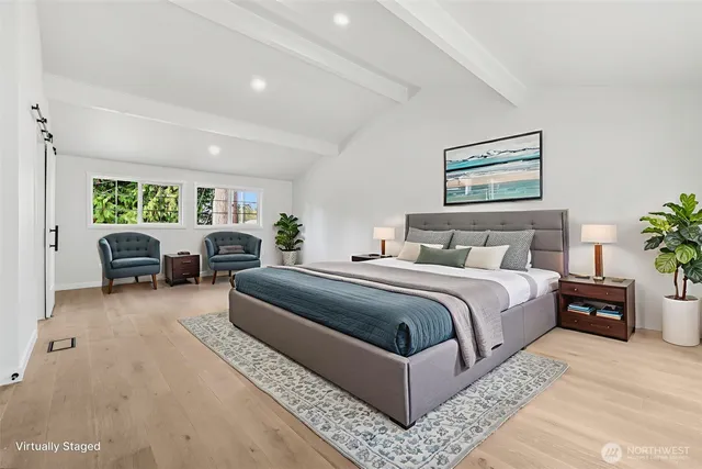 an empty room with windows and refrigerator