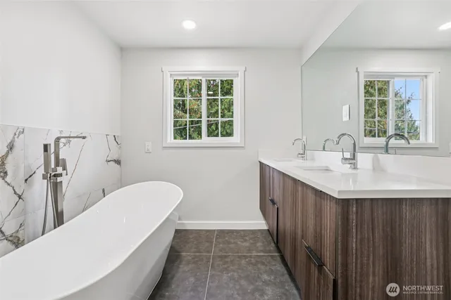 a spacious bathroom with a sink a toilet and shower