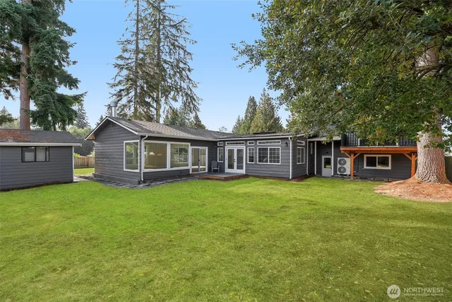 a view of a house with a yard and sitting area