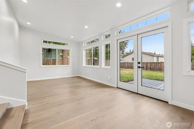 a view of an empty room with glass door