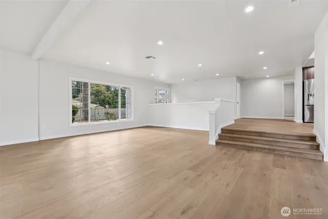 a view of an empty room with a fireplace