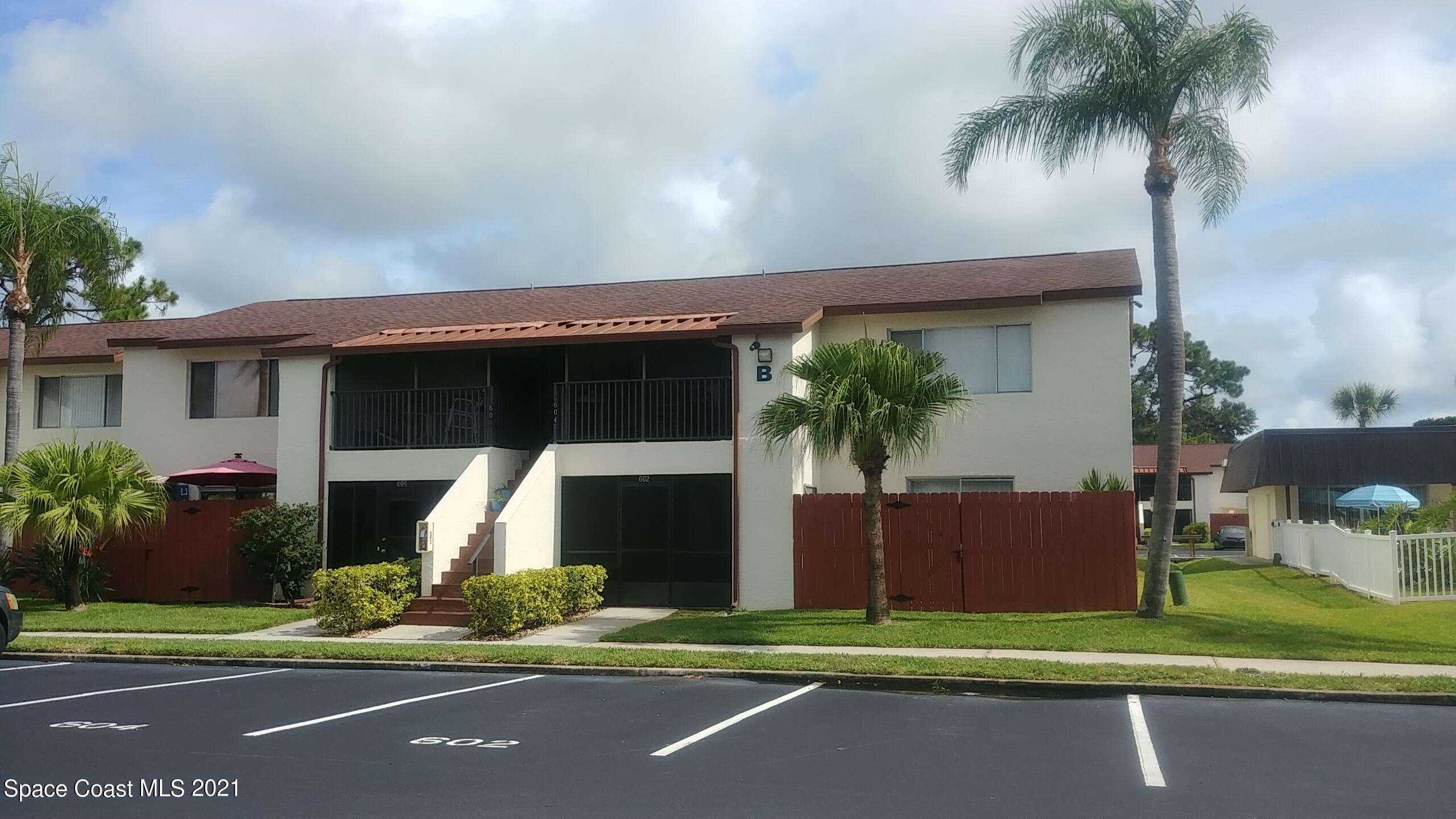 604 Ridge Club Drive, Unit 96 Melbourne, FL 32934 - Photo 1 of 17 a front view of a house with a garden and yard