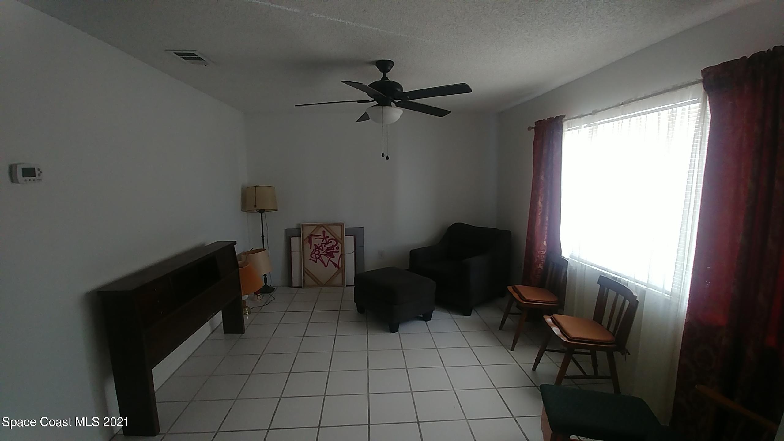 604 Ridge Club Drive, Unit 96 Melbourne, FL 32934 - Photo 8 of 17 a living room with furniture and a window
