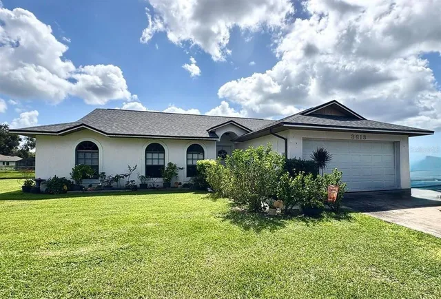 a front view of house with yard and garage