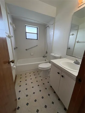 a bathroom with a sink a toilet a shower a mirror and vanity