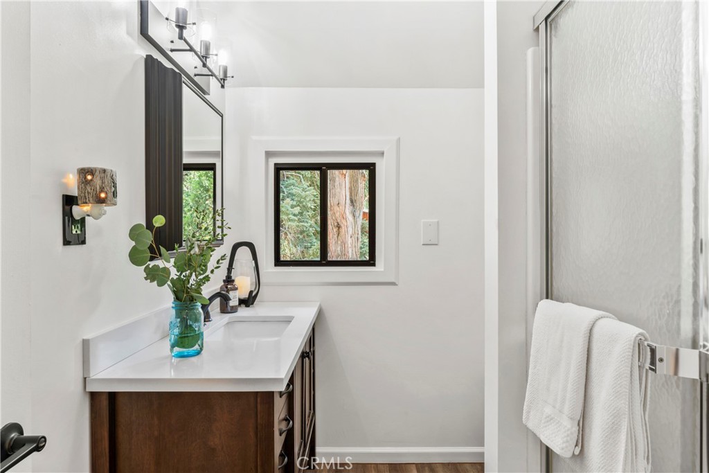 899 Blue Ridge Drive Lake Arrowhead, CA 92385 - Photo 27 of 49 a room with a sink and a mirror