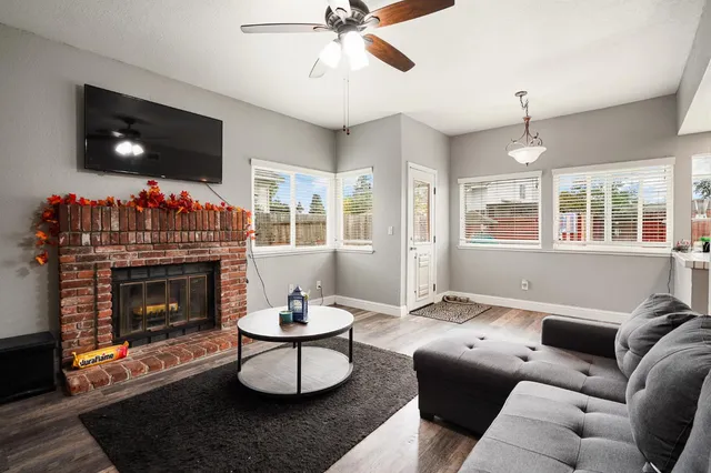 a living room with furniture a window and a fireplace