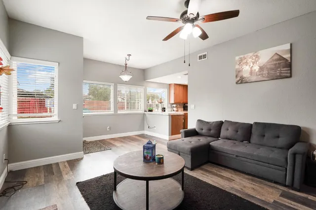 a living room with furniture a rug and a chandelier
