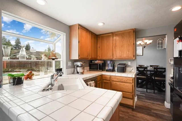 a kitchen with stainless steel appliances granite countertop a refrigerator and a stove