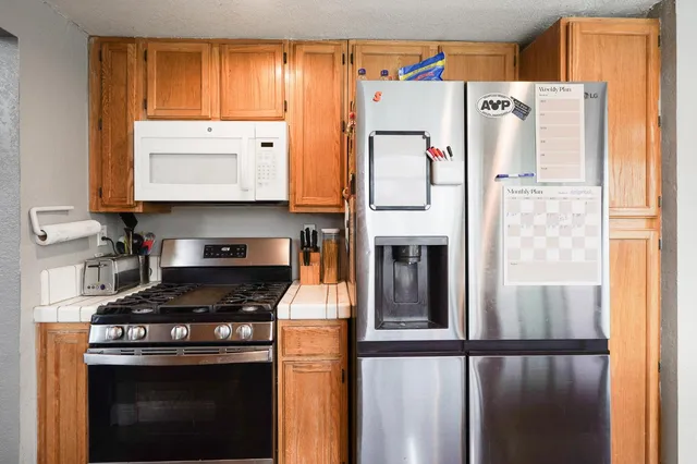 a kitchen with a sink stove and cabinets