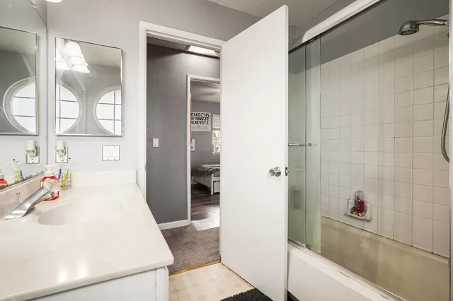 a bedroom with a bed and a dresser in it