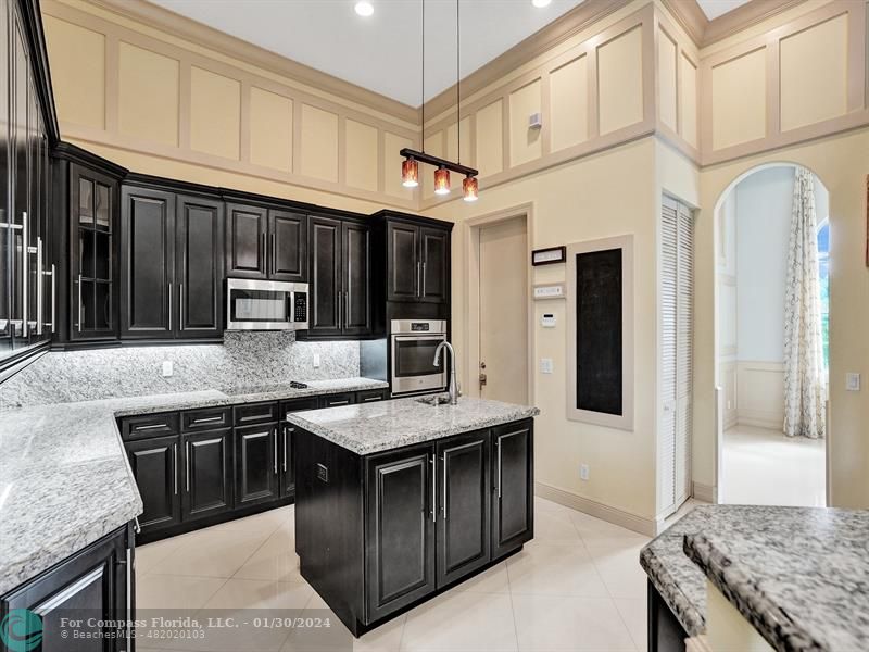 1965 Park Place Boca Raton, FL 33486 - Photo 11 of 30 a kitchen with stainless steel appliances granite countertop a stove a sink and a refrigerator