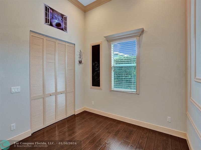 1965 Park Place Boca Raton, FL 33486 - Photo 20 of 30 an empty room with wooden floor and windows