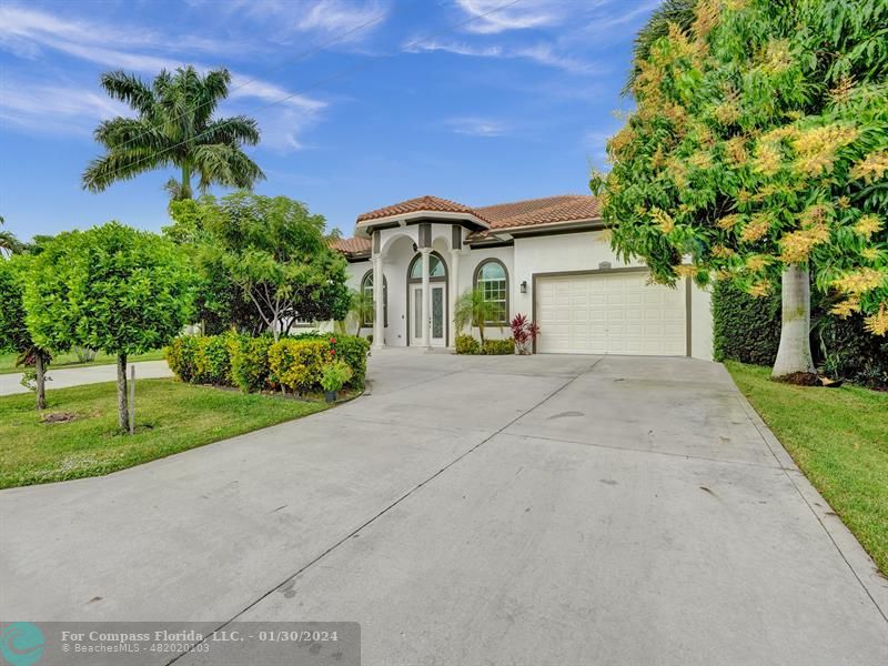 1965 Park Place Boca Raton, FL 33486 - Photo 29 of 30 a front view of a house with a yard and garage