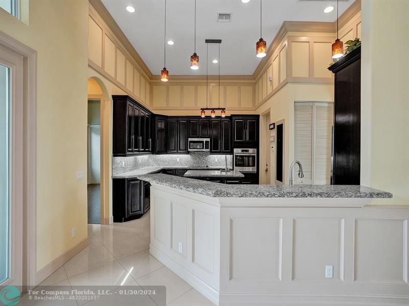 1965 Park Place Boca Raton, FL 33486 - Photo 8 of 30 a kitchen with stainless steel appliances granite countertop a sink a stove and a refrigerator