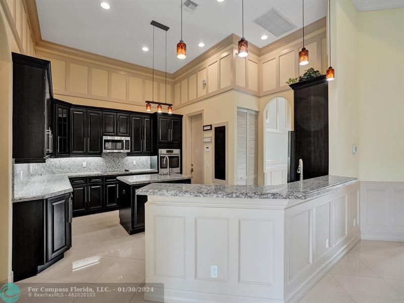 1965 Park Place Boca Raton, FL 33486 - Photo 9 of 30 a kitchen with stainless steel appliances granite countertop a sink a stove and a refrigerator
