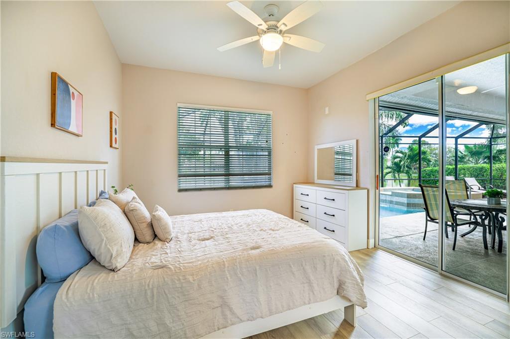 5235 Malvern Court Naples, FL 34112 - Photo 21 of 28 a bed sitting in a bedroom next to a window