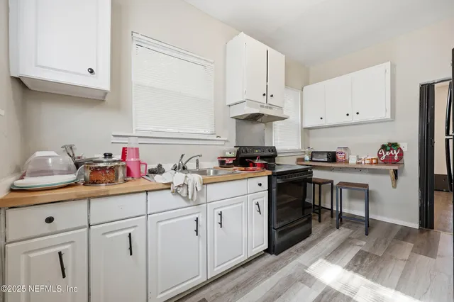 a kitchen with cabinets and appliances
