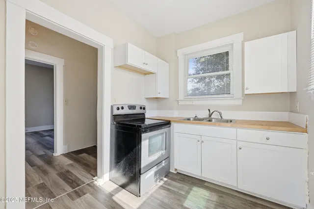 a kitchen with a stove and a sink