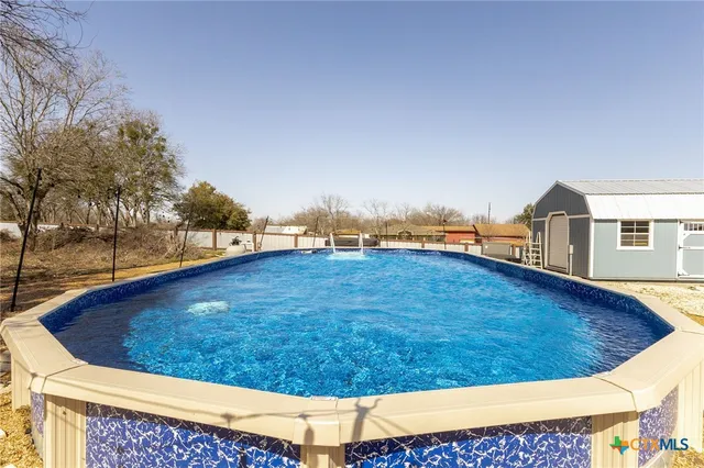 a front view of a house with a swimming pool
