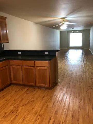 a view of a room with wooden floor