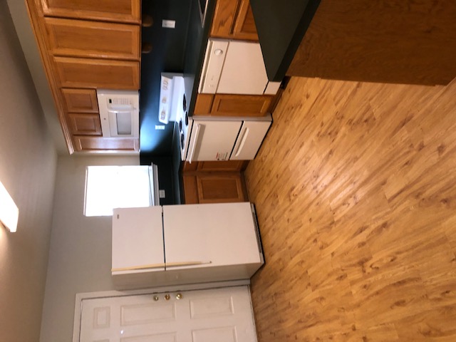 908 Willow Pond Street College Station, TX 77845 - Photo 4 of 7 a kitchen with granite countertop a refrigerator a sink and white cabinets