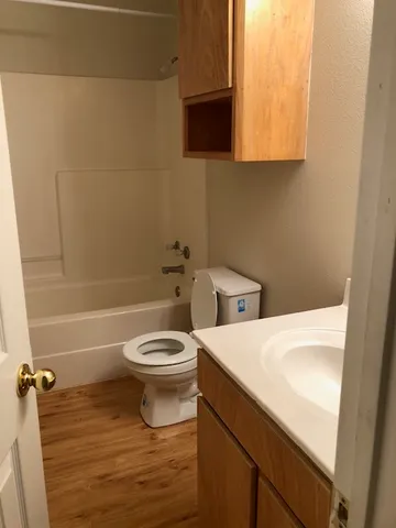 a bathroom with a sink a toilet and bathtub