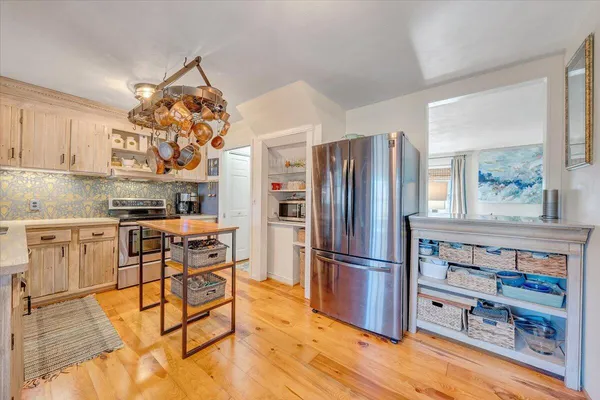 a living room with furniture a fireplace and a floor to ceiling window
