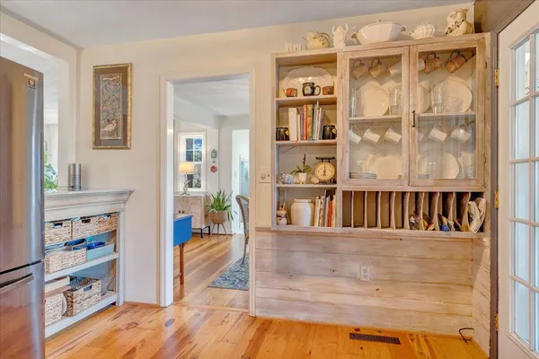 a living room with furniture large window and wooden floor
