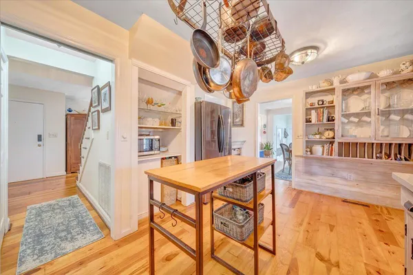a living room with furniture a fireplace and a large window