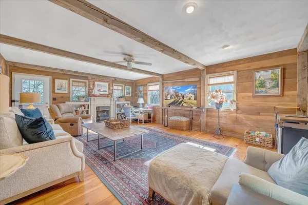 a living room with furniture a table and a large window