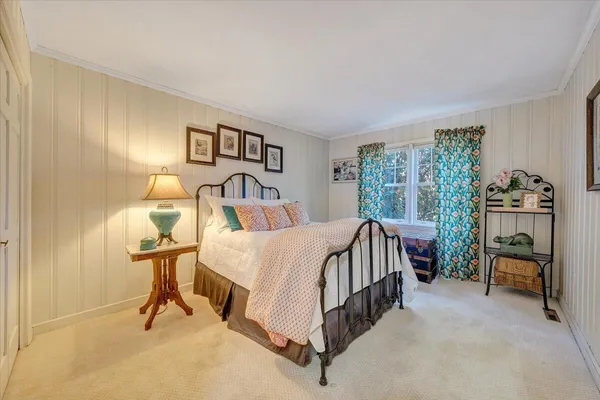 a living room with fireplace furniture and a large window