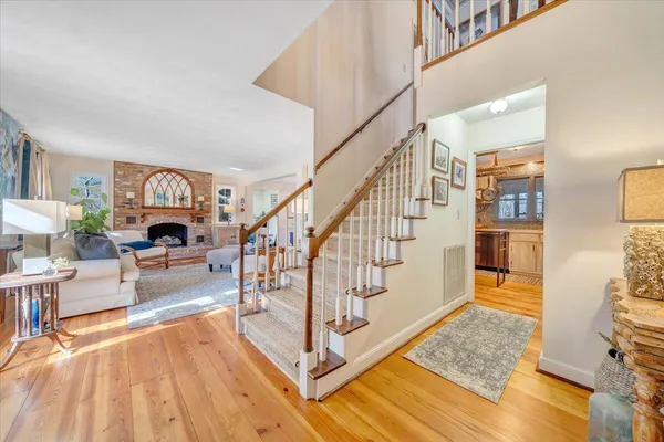 a living room with furniture fireplace and a large window
