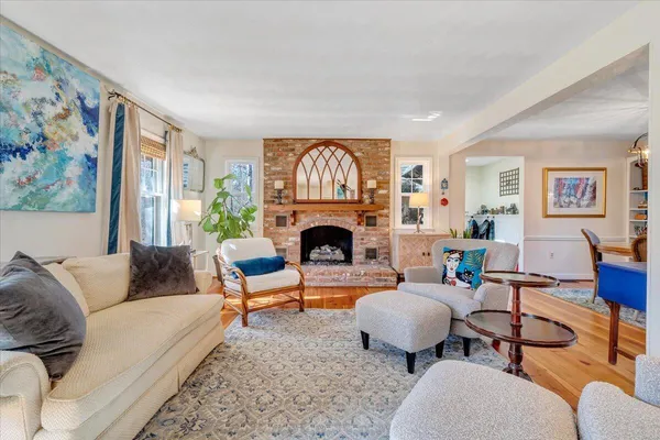 a living room with furniture a fireplace and a table