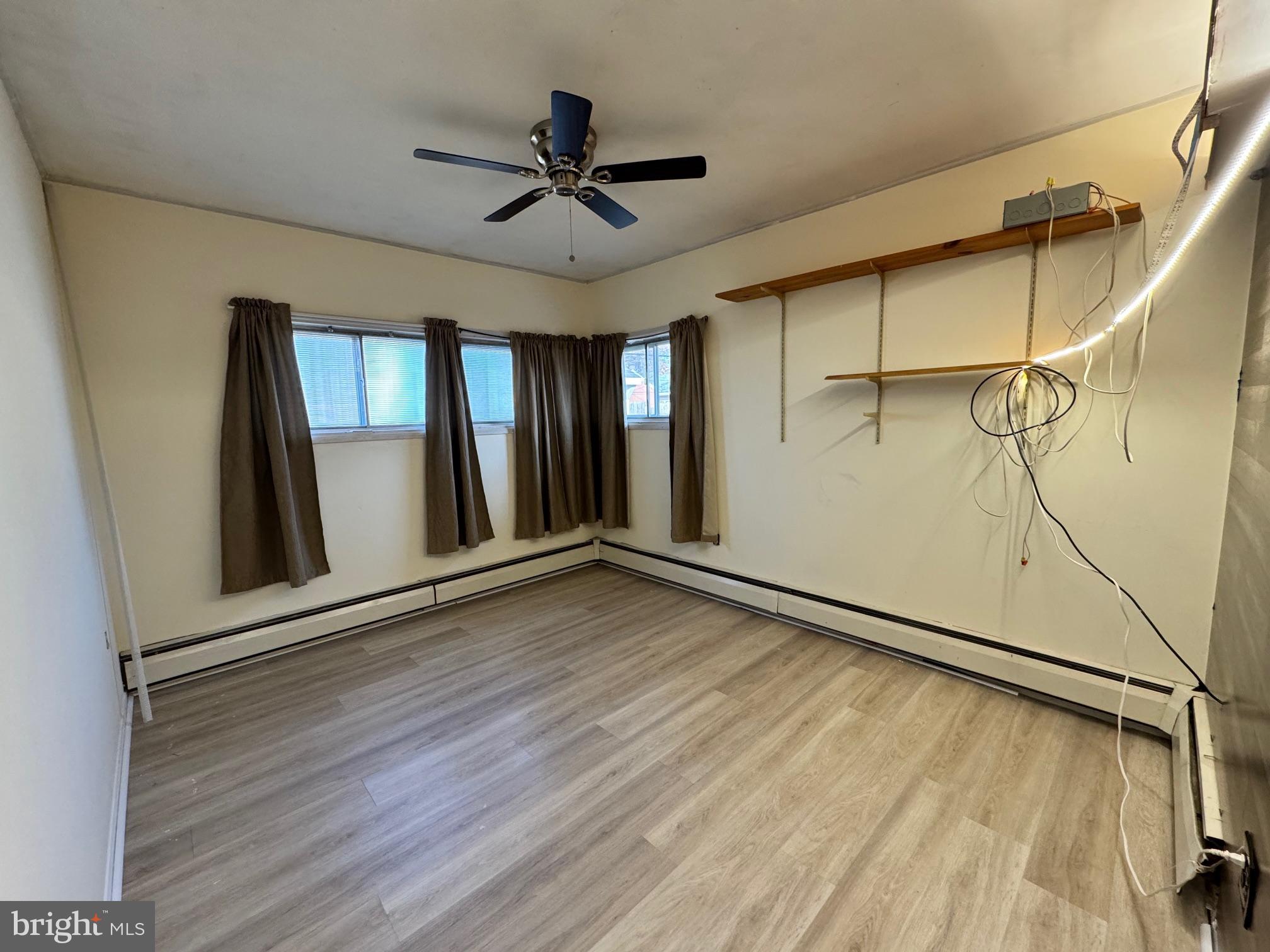 31 Swan Lane Levittown, PA 19055 - Photo 13 of 17 a view of an empty room with a window and wooden floor