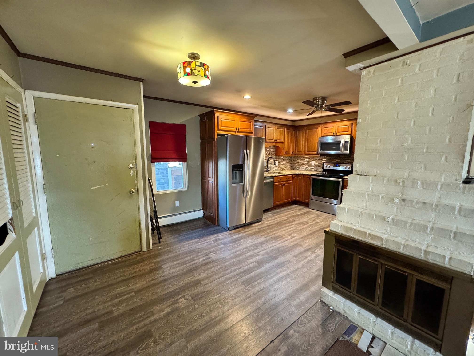 31 Swan Lane Levittown, PA 19055 - Photo 7 of 17 a kitchen with stainless steel appliances granite countertop a refrigerator and a stove top oven