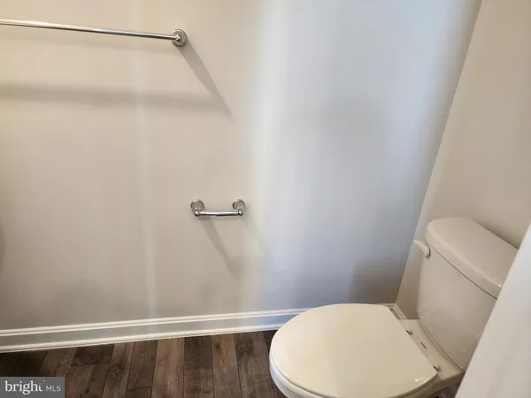 a white toilet sitting next to a shower
