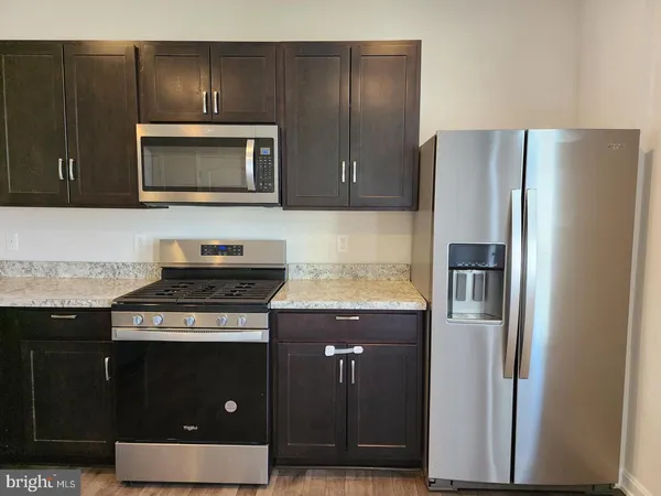 a kitchen with a stove and a microwave