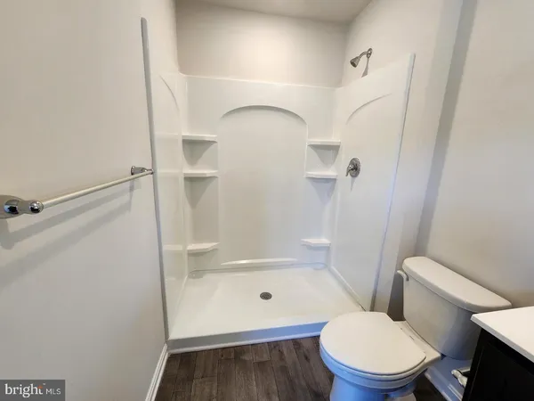 a bathroom with a toilet and a shower