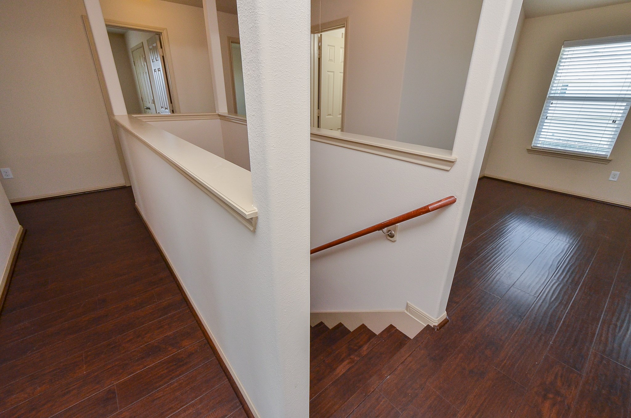 25135 Ginger Ranch Drive Katy, TX 77494 - Photo 15 of 32 An open landing area with wood-style flooring overlooks the staircase and provides access to surrounding rooms.