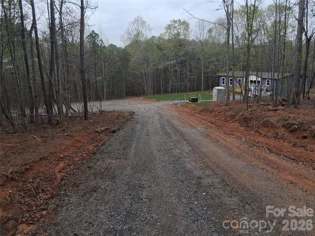a view of a backyard with large trees