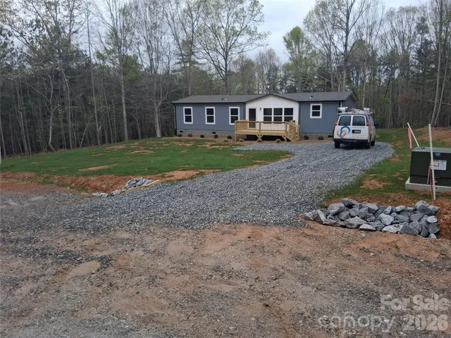 a view of a house with a yard and sitting area