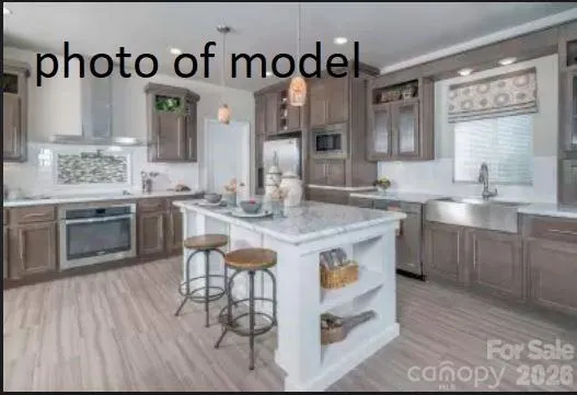 a kitchen with stainless steel appliances granite countertop a sink and cabinets