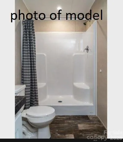 a bathroom with a toilet and a shower