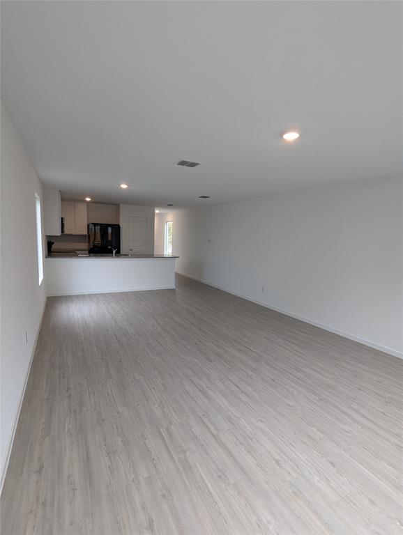 904 Wood Stork Way Princeton, TX 75407 - Photo 11 of 40 a view of a room with wooden floor and window